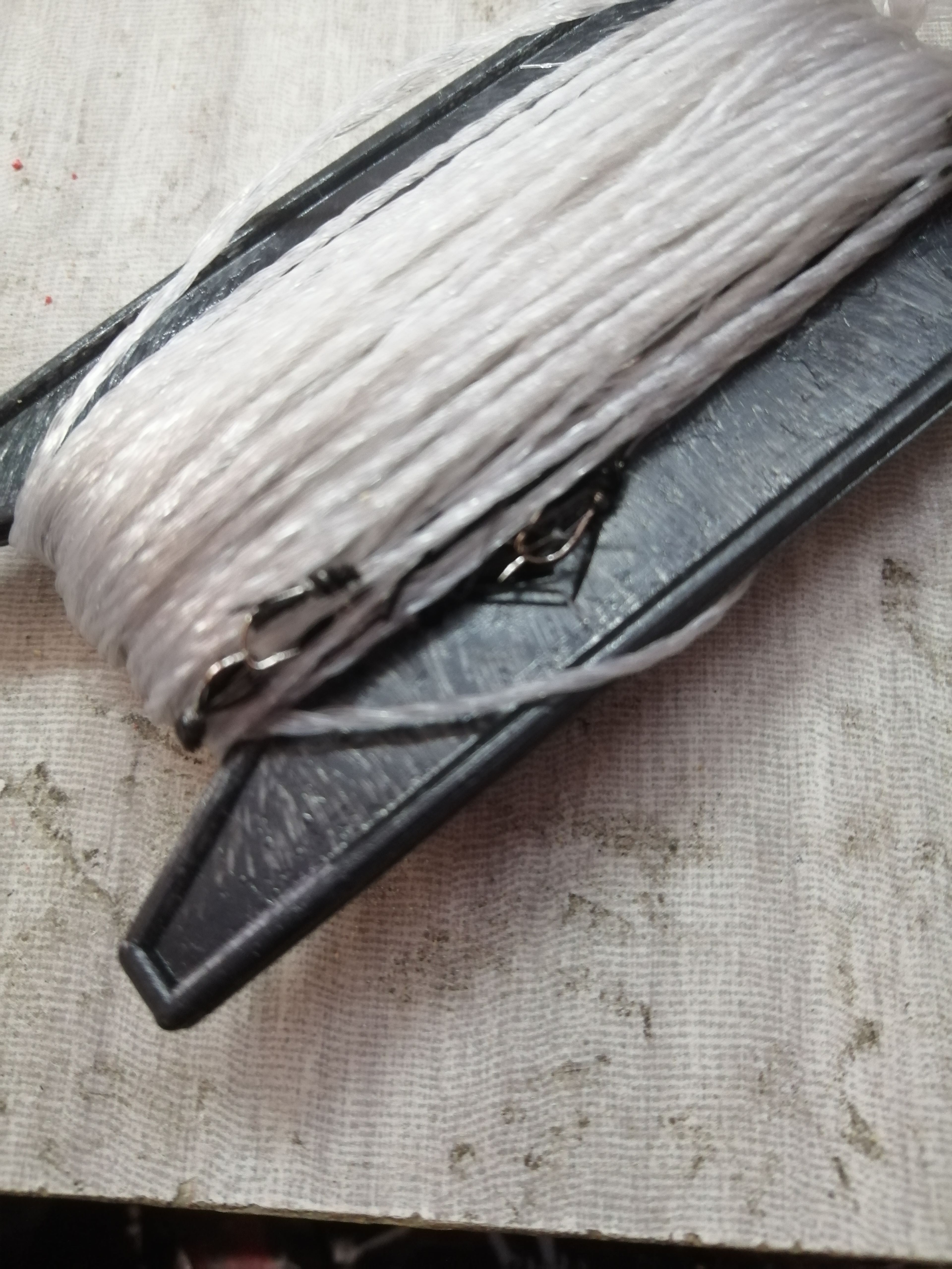 White hook, black and yellow cuffs, number three, 28-30 hooks, around 10 cm